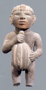 A statue of a man holding a cacao bean